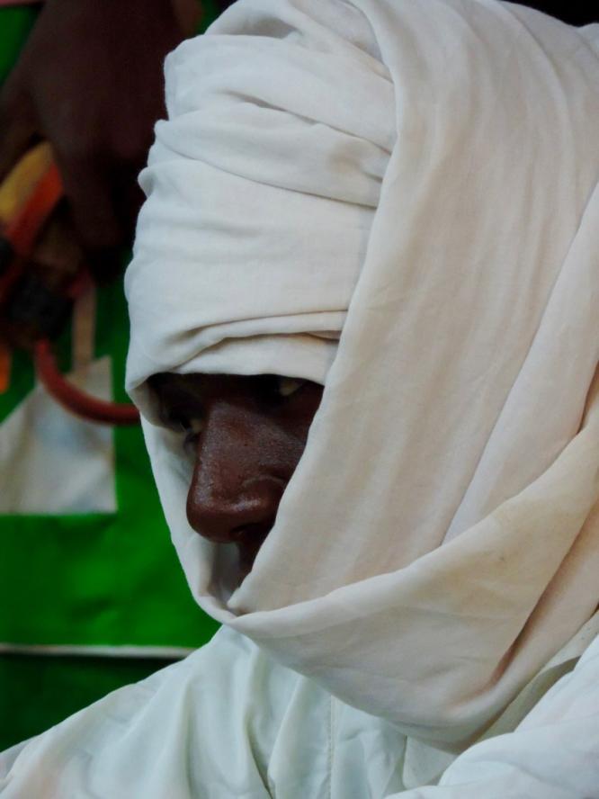 A refugee man with his head covered in a white cloth in Burkina Faso 