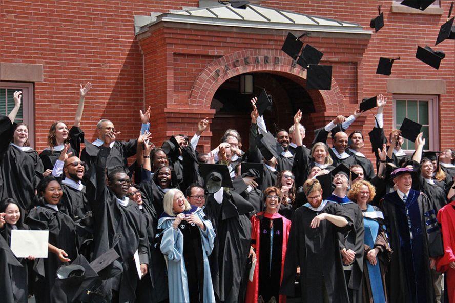 Fletcher School graduates toss their caps into the air