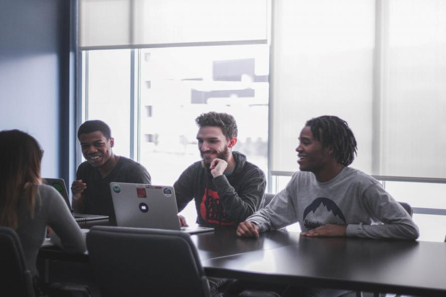 Student group around laptop; Hunter Newton, Unsplash