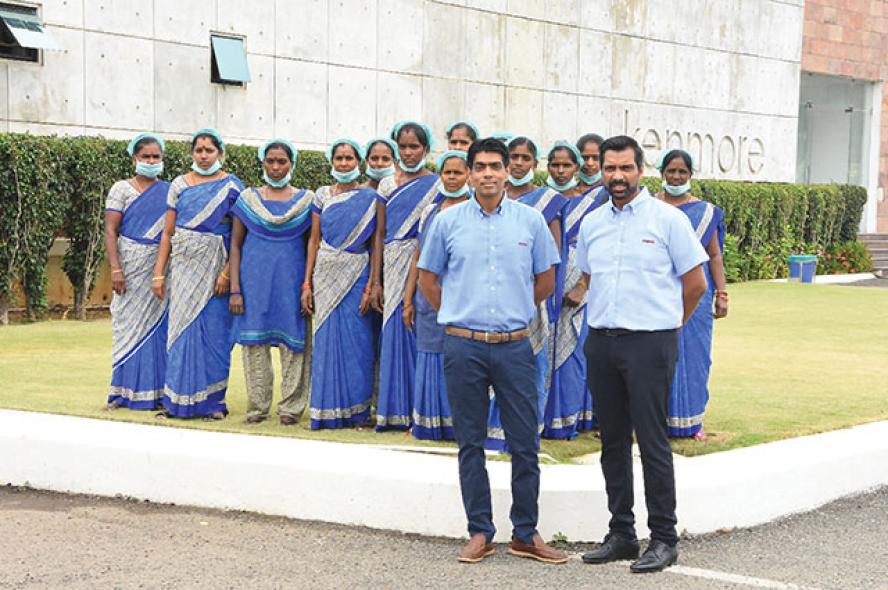 Two brothers stand with their employees. The brothers behind the Farida Group give every employee their cell phone numbers, wear uniforms to work, and refuse to promise jobs to their kids. It just might keep the family enterprise afloat.