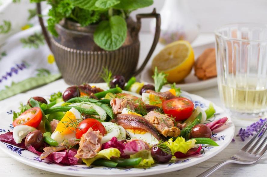 Cold salad on a plate with fresh herbs