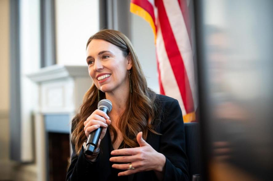 Jacinda Ardern, former prime minister of New Zealand, holding a microphone