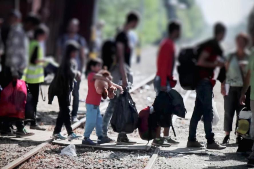 A group of people cross railroad tracks covered over with cardboard. Refugees and asylum-seekers fleeing violence and persecution can adapt more quickly with support of their diaspora communities, says expert