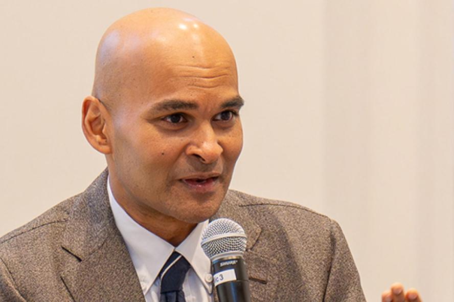 Reihan Salam speaking into a microphone held in his right hand