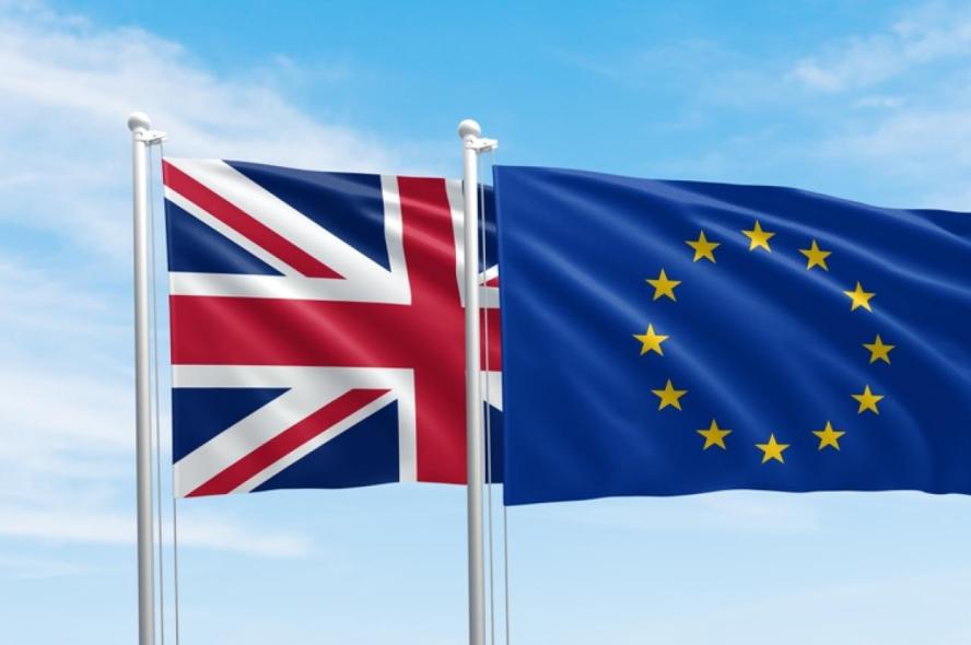 Flags of the United Kingdom and European Union fly side-by-side. 