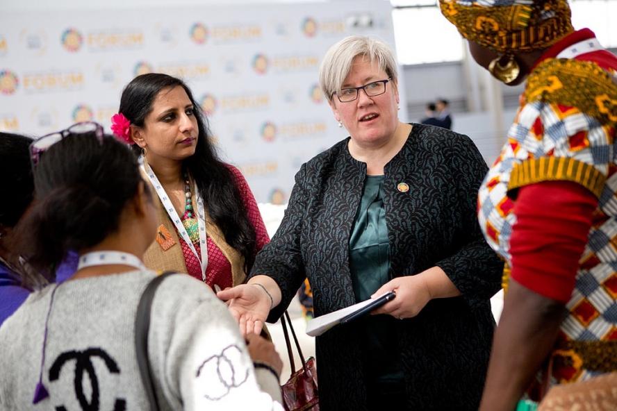 Rachel Kye, new dean of the Fletcher School, pictured talking with a small group of women.