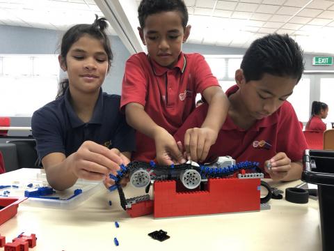 School children in New Zealand work on a project with legos