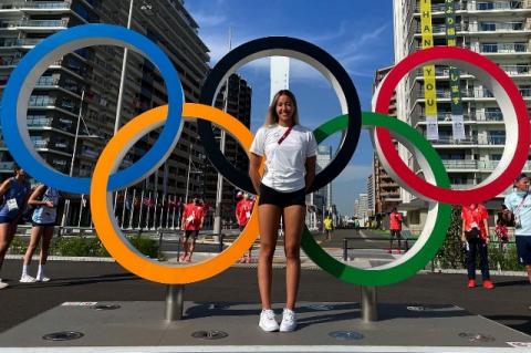 Tufts student Gaurika Singh stands in front of the Olympic rings in Tokyo, Japan