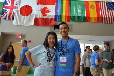 Students standing in front of international flags