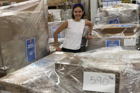 Michelle Ramirez with boxes of relief supplies for Puerto Rico