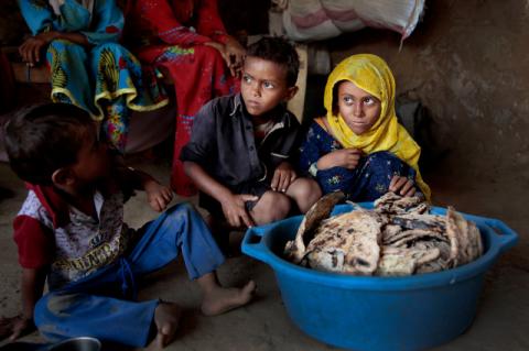 children with basket of moldy bread in Yemen
