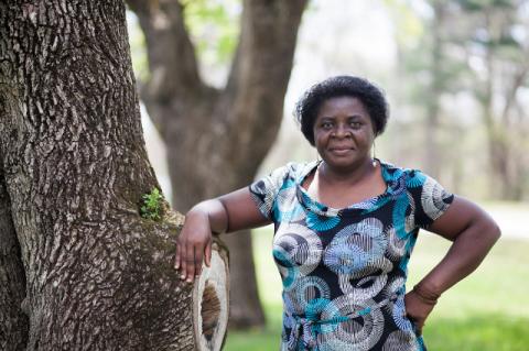 A woman standing in front of a tree. The Tufts Institute of the Environment marks its twentieth anniversary with a program celebrating two decades of activism.