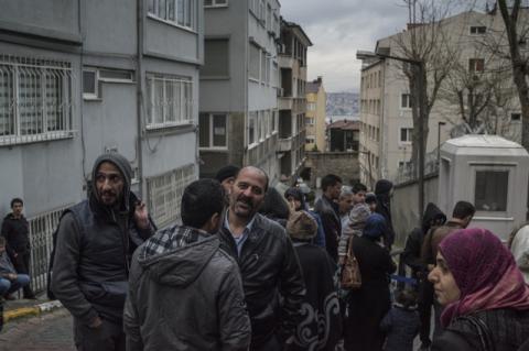 Refugees line up on a street corner in Istanbul. Turkey is pushing refugees to return to Syria in response to shifting public opinion and a desire for a buffer zone on his southern border, says Fletcher School professor