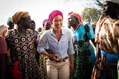 A group of women in a Ugandan village. Tufts alums are helping Ugandan women grow strong roots and reach new heights through financial, literacy, and agricultural programs