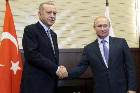 Two men shaking hands. Why Russia is the new Middle East power broker; the U.S. withdrawal from a previously Kurdish-controlled region gives Russia even more influence in the region