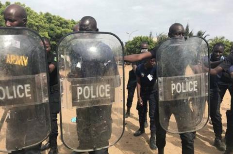 Police officers in Senegal stand with shields as they receive training in crowd control. Fletcher School graduate Querine Hanlon leads assistance programs to help make nations’ military and police forces more effective and accountable, as part of broader efforts in security sector reform.