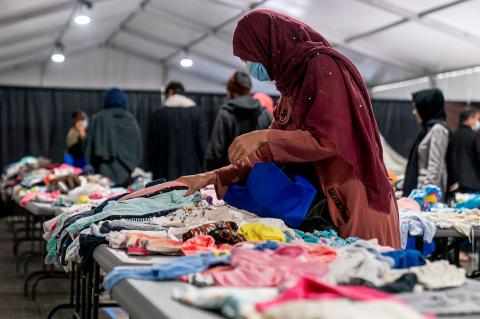 Afghans at a military facility in New Jersey in September choose clothing