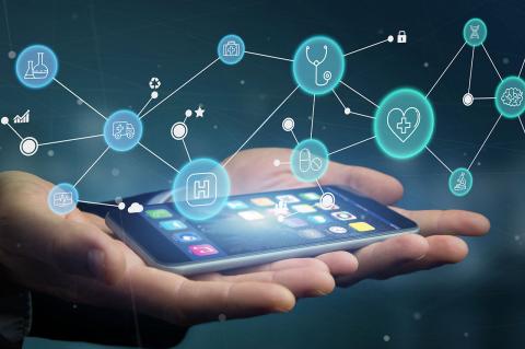 Hands holding a mobile phone with futuristic medical icons illustrated over the phone