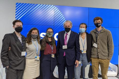 Tufts students and a Tufts graduate stand with U.S. Sen. Edward Markey of Massachusetts at the United Nations Climate Change Conference in Glasgow.