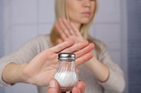 Woman refusing a salt shaker