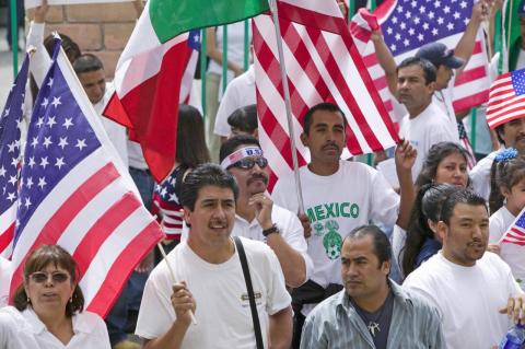 A group of Mexican-Americans at a protest, flying U.S, and Mexican flags. Skin color tone is found to shape the experiences of Mexican immigrants in Atlanta and Philadelphia.