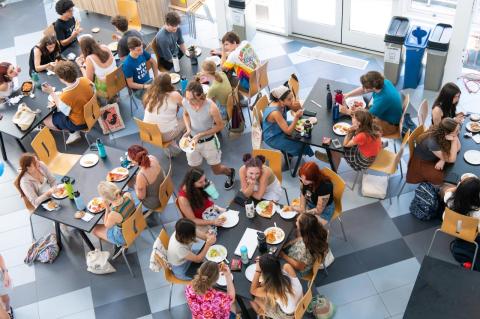 A view from above of Tufts University students eating lunch at tables