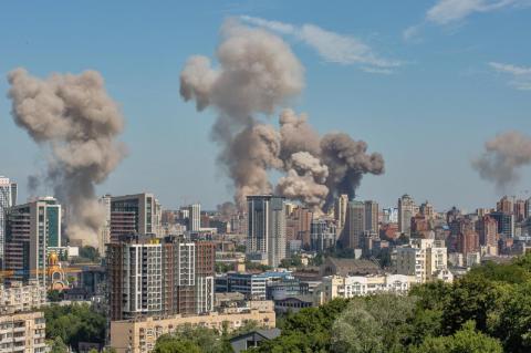 Broad view of the skyline of Kyiv, with three pillars of brown smoke from fires in two locations. Despite more than three years of brutal conflict, Ukrainians are still mostly unified in fighting off Russian invaders, says political scientist.