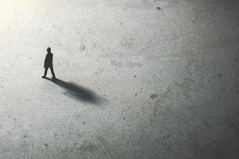 man walking in the night toward the light