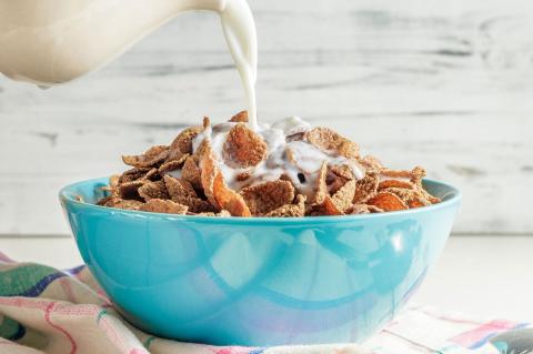 Am I Getting Enough B Vitamins? A bowl of fortified bran flakes cereal with milk being poured over it