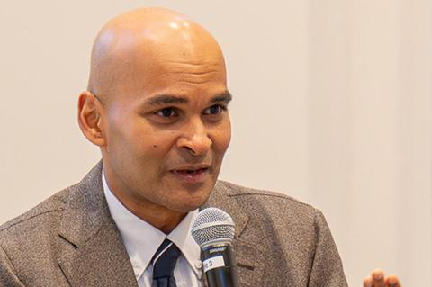 Reihan Salam speaking into a microphone held in his right hand