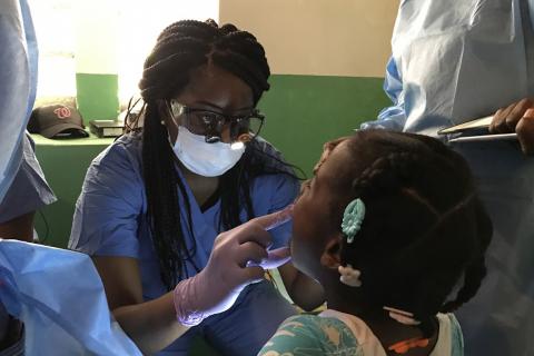 a doctor looking into a child's mouth