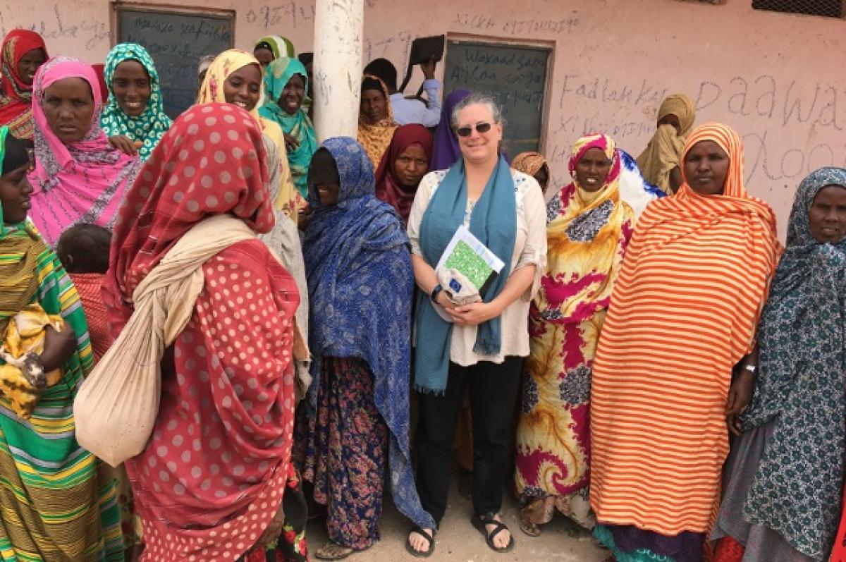 The Veterinarian-Humanitarian Christine Jost with a number of Somali women. A Cummings School and Fletcher School alum, Jost works to get U.S. aid where it’s needed to fight COVID-19, locusts, and other emergencies across the globe