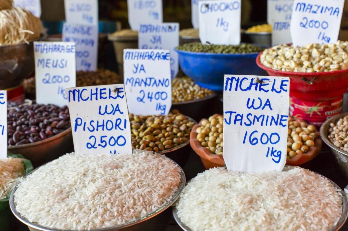 bowls of grains with handwritten price tags in an African market